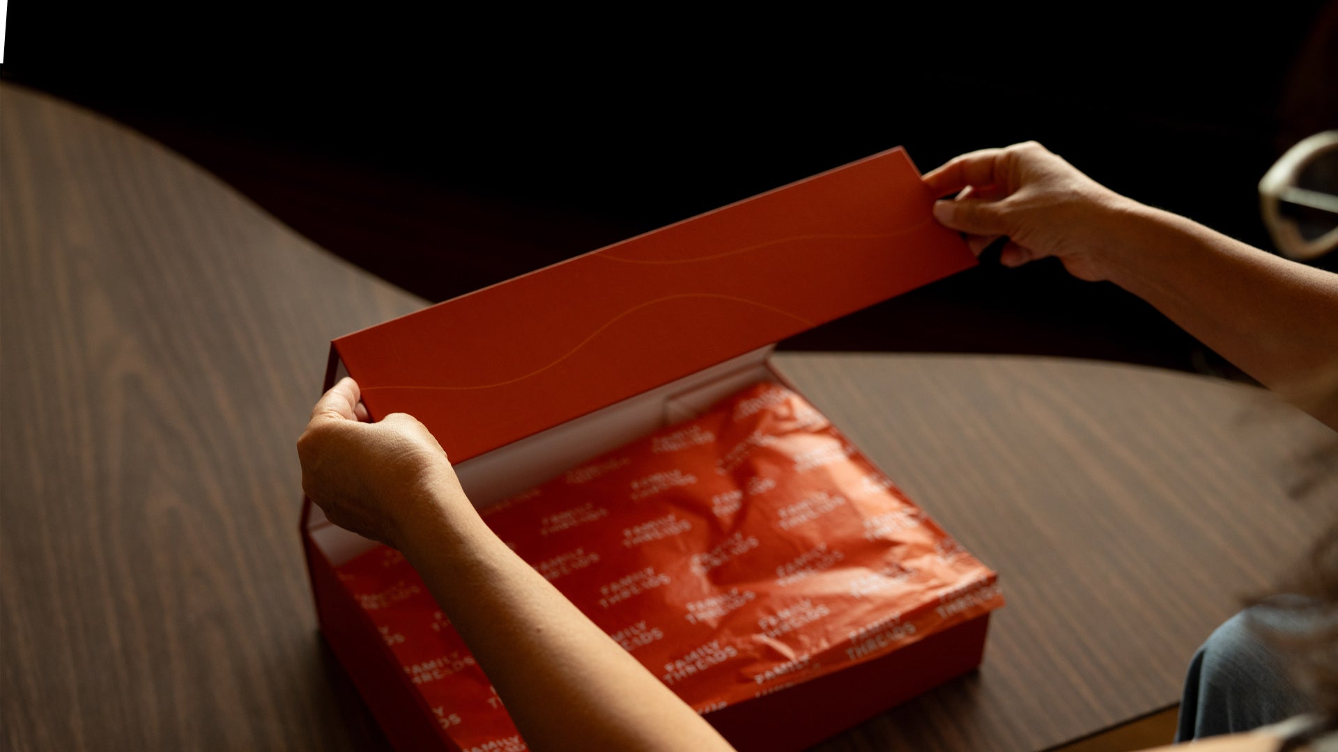 Founder quote over a softly blurred heirloom gift box being opened.