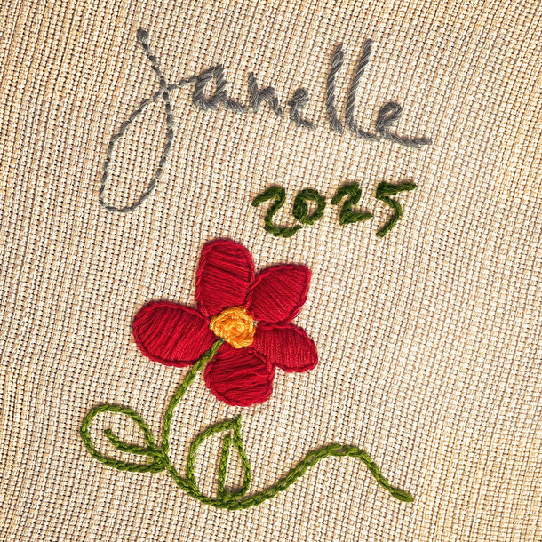 Hand-stitched embroidered name and flower design on the Family Threads keepsake tablecloth.